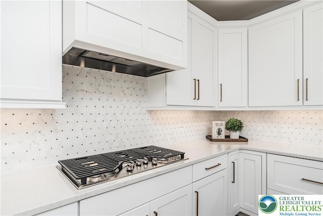 2638 Hollow View Dr, Forks Twp, PA 18040 - kitchen featuring stainless steel gas stovetop, custom range hood, white cabinets, and light countertops