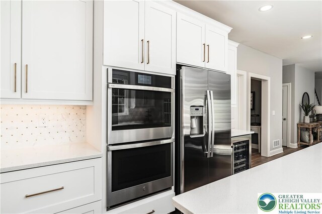 2638 Hollow View Dr, Forks Twp, PA 18040 - kitchen with appliances with stainless steel finishes, beverage cooler, light countertops, decorative backsplash, and recessed lighting