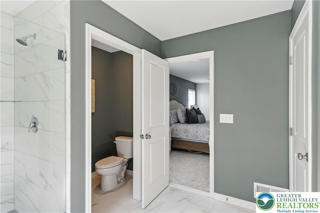 2638 Hollow View Dr, Forks Twp, PA 18040 - ensuite bathroom featuring marble look tiles, toilet, a marble finish shower, and baseboards