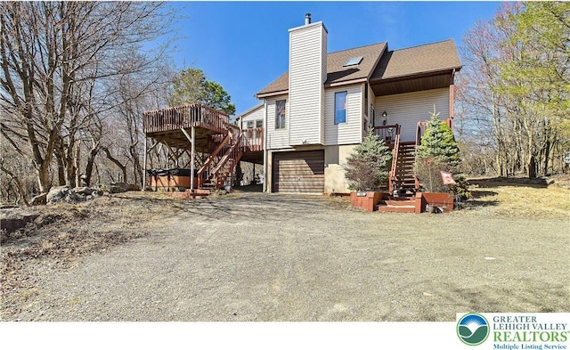177 Dogwood Ter, Tunkhannock Township, PA 18210 - back of house featuring stairway, a chimney, a garage, and a deck