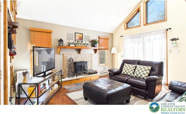 177 Dogwood Ter, Tunkhannock Township, PA 18210 - living area with a wood stove, wood finished floors, high vaulted ceiling, and baseboard heating
