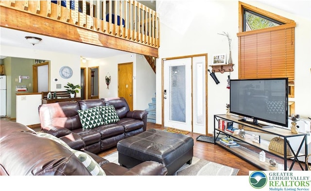 177 Dogwood Ter, Tunkhannock Township, PA 18210 - living room with wood finished floors, high vaulted ceiling, and stairway