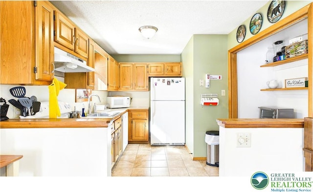 177 Dogwood Ter, Tunkhannock Township, PA 18210 - kitchen with white appliances, under cabinet range hood, light countertops, a sink, and light tile patterned floors