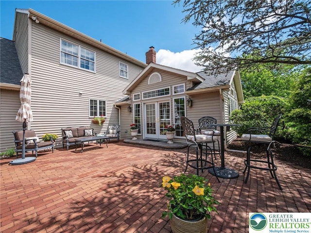 3840 E View Dr, North Whitehall Twp, PA 18069 - back of house featuring french doors, an outdoor hangout area, a patio, and a chimney