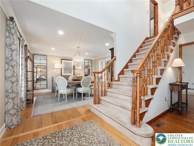 3840 E View Dr, North Whitehall Twp, PA 18069 - staircase featuring wood finished floors, a chandelier, baseboards, ornamental molding, and recessed lighting