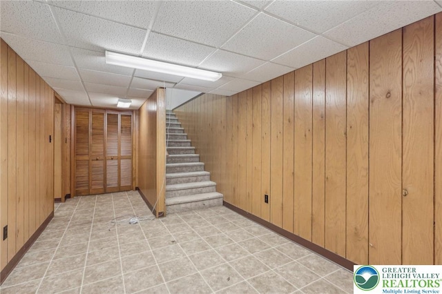 1450 Springhouse Rd, South Whitehall Twp, PA 18104 - finished below grade area with wood walls, a paneled ceiling, stairs, and baseboards