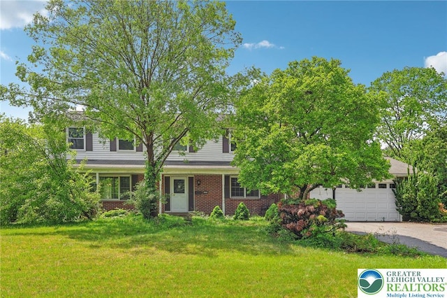 1450 Springhouse Rd, South Whitehall Twp, PA 18104 - view of front facade with driveway, a front lawn, a garage, and brick siding