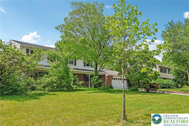 1450 Springhouse Rd, South Whitehall Twp, PA 18104 - obstructed view of property with an attached garage and a front yard
