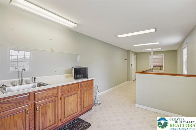 1450 Springhouse Rd, South Whitehall Twp, PA 18104 - kitchen with a sink, light floors, brown cabinetry, light countertops, and plenty of natural light