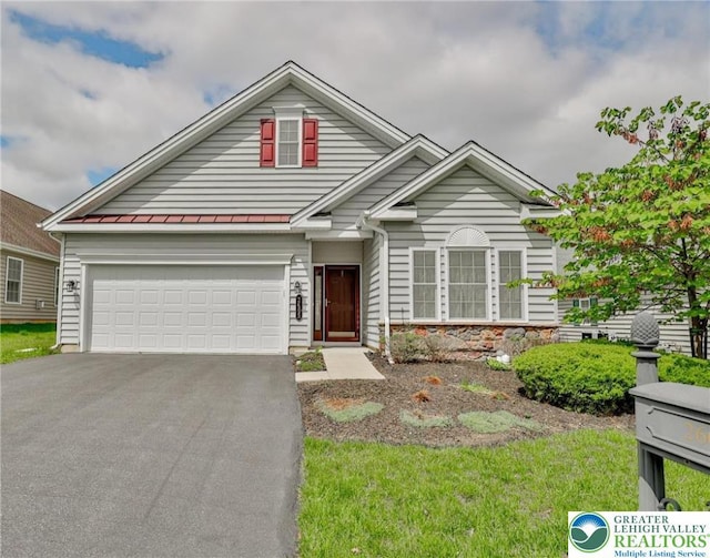 2605 Victory Way, Hanover Twp, PA 18017 - traditional-style home featuring driveway, a standing seam roof, metal roof, and an attached garage