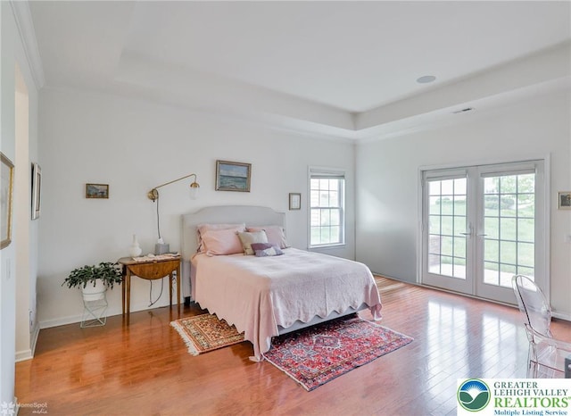 2605 Victory Way, Hanover Twp, PA 18017 - bedroom with access to exterior, a raised ceiling, wood finished floors, french doors, and baseboards