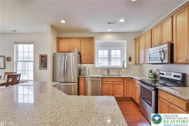 2605 Victory Way, Hanover Twp, PA 18017 - kitchen featuring appliances with stainless steel finishes, a sink, recessed lighting, light stone counters, and wood finished floors
