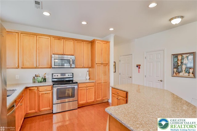 2605 Victory Way, Hanover Twp, PA 18017 - kitchen featuring stainless steel appliances, light wood-type flooring, recessed lighting, a center island, and light stone countertops