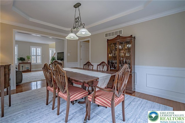 4408 Irish Creek Rd, Pa, PA 19506 - dining area with a tray ceiling, wood finished floors, a wainscoted wall, and ornamental molding