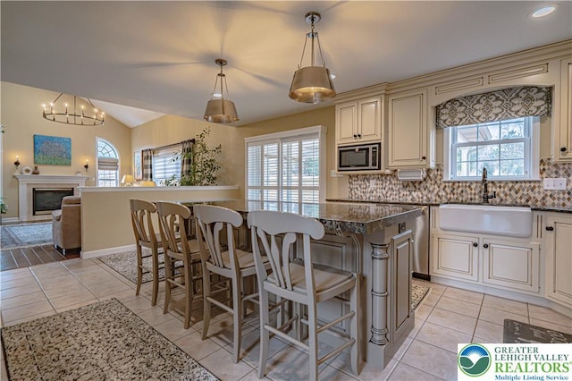 4408 Irish Creek Rd, Pa, PA 19506 - kitchen with cream cabinets, stainless steel microwave, a sink, plenty of natural light, and vaulted ceiling