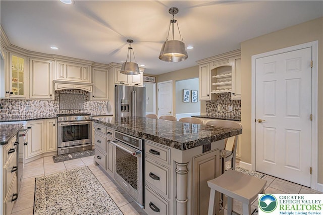 4408 Irish Creek Rd, Pa, PA 19506 - kitchen with cream cabinetry, stainless steel appliances, light tile patterned flooring, tasteful backsplash, and recessed lighting