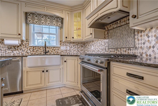 4408 Irish Creek Rd, Pa, PA 19506 - kitchen featuring cream cabinets, appliances with stainless steel finishes, a sink, custom exhaust hood, and light tile patterned floors