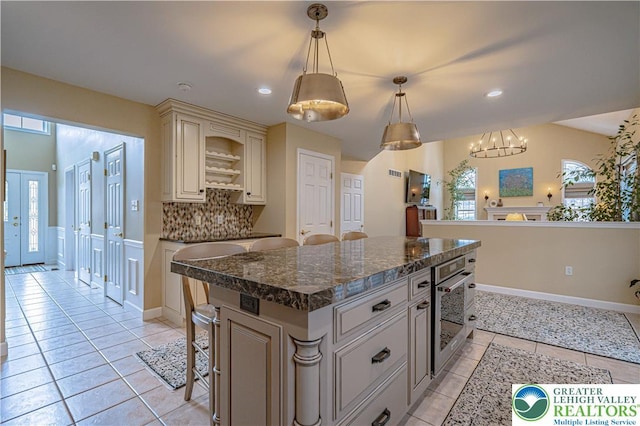 4408 Irish Creek Rd, Pa, PA 19506 - kitchen featuring oven, cream cabinetry, light tile patterned flooring, tasteful backsplash, and recessed lighting