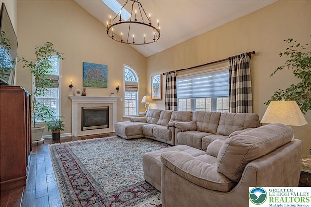 4408 Irish Creek Rd, Pa, PA 19506 - living area featuring a chandelier, healthy amount of natural light, high vaulted ceiling, hardwood / wood-style floors, and a glass covered fireplace