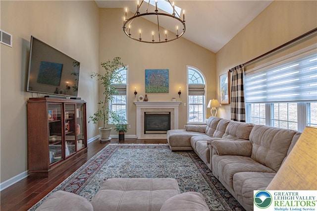 4408 Irish Creek Rd, Pa, PA 19506 - living room with a chandelier, high vaulted ceiling, baseboards, a glass covered fireplace, and wood finished floors