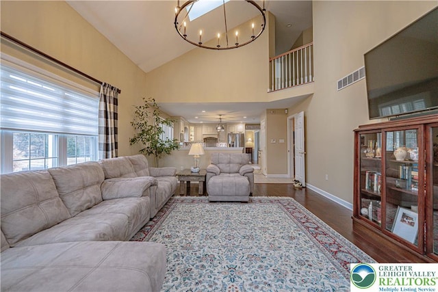 4408 Irish Creek Rd, Pa, PA 19506 - living room with dark wood-style flooring, a chandelier, baseboards, and high vaulted ceiling