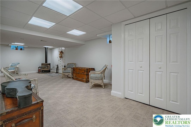 4408 Irish Creek Rd, Pa, PA 19506 - sitting room featuring a wood stove, carpet, a drop ceiling, and baseboards