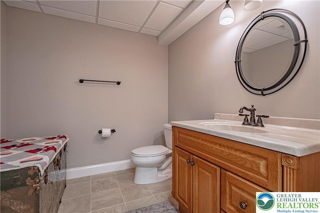 4408 Irish Creek Rd, Pa, PA 19506 - half bath with vanity, toilet, a paneled ceiling, baseboards, and tile patterned flooring
