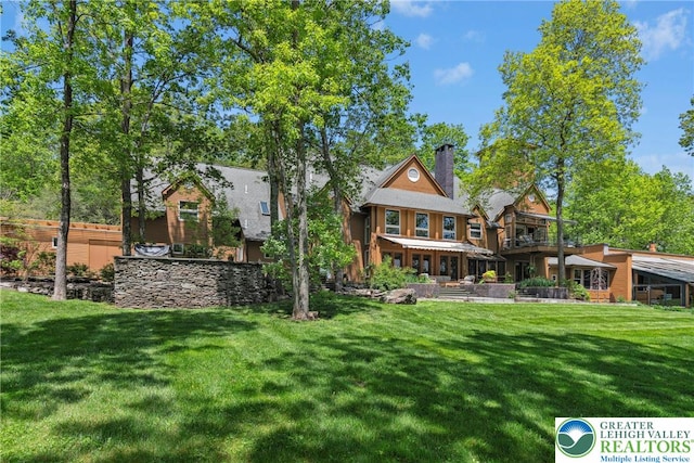 310 Hunters Farm Rd, Paradise Twp, PA 18332 - rear view of house with a yard and a chimney