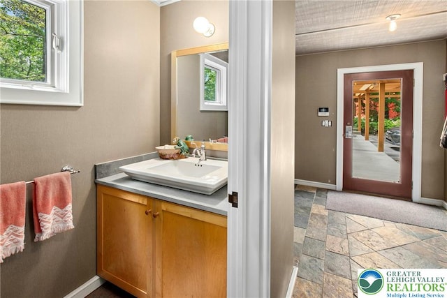 310 Hunters Farm Rd, Paradise Twp, PA 18332 - bathroom featuring plenty of natural light, stone tile floors, and vanity
