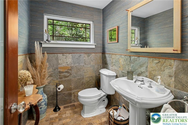 310 Hunters Farm Rd, Paradise Twp, PA 18332 - bathroom featuring tile walls, toilet, and wainscoting