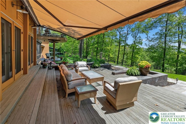 310 Hunters Farm Rd, Paradise Twp, PA 18332 - wooden deck featuring an outdoor living space and view of scattered trees