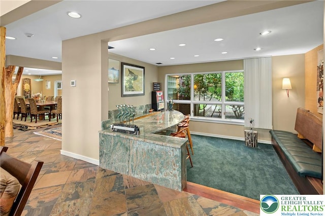 310 Hunters Farm Rd, Paradise Twp, PA 18332 - carpeted dining space with baseboards, recessed lighting, stone finish flooring, and bar