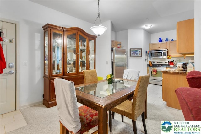 2121 Hokendauqua Ave Unit 210, Northampton Borough, PA 18067 - dining area featuring light tile patterned flooring and light carpet
