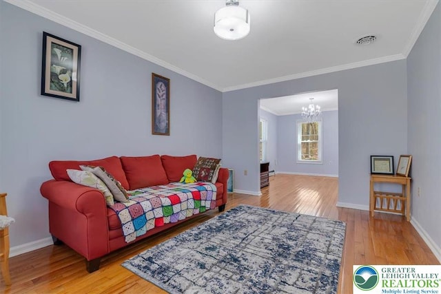 190 Reunion Rdg, Stroud Twp, PA 18301 - living room featuring a chandelier, wood finished floors, ornamental molding, and baseboards