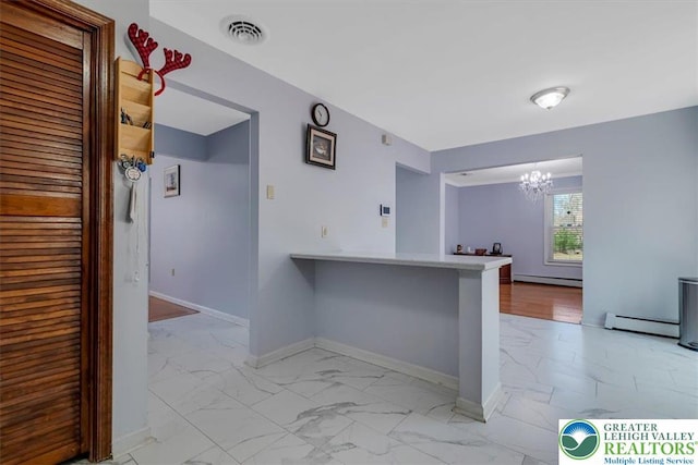 190 Reunion Rdg, Stroud Twp, PA 18301 - kitchen featuring light marble finish flooring, baseboard heating, a chandelier, and baseboards