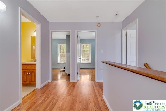 190 Reunion Rdg, Stroud Twp, PA 18301 - hall with light wood finished floors, a baseboard heating unit, and baseboards