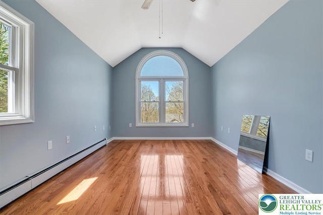 190 Reunion Rdg, Stroud Twp, PA 18301 - spare room with baseboard heating, hardwood / wood-style floors, a ceiling fan, vaulted ceiling, and baseboards