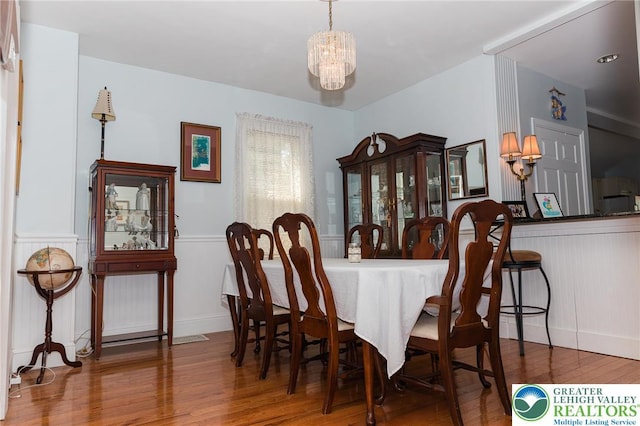 433 S 19th St, Easton, PA 18042 - dining area featuring wood finished floors, a chandelier, and a wainscoted wall