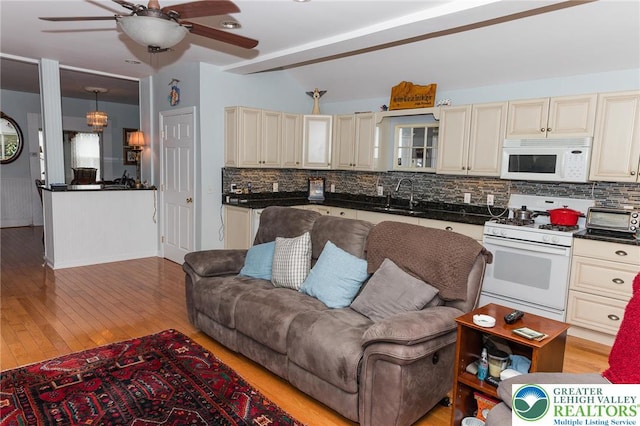 433 S 19th St, Easton, PA 18042 - living room featuring a ceiling fan, light wood-style flooring, and beamed ceiling