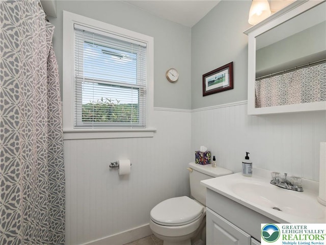 30 Morgan Hill Rd, Williams Twp, PA 18042 - bathroom featuring a wainscoted wall, vanity, toilet, and a shower with shower curtain