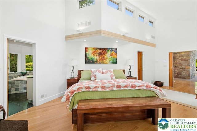 511 Center Hill Rd, Nockamixon Twp, PA 18972 - bedroom with a towering ceiling, wood finished floors, connected bathroom, and baseboards