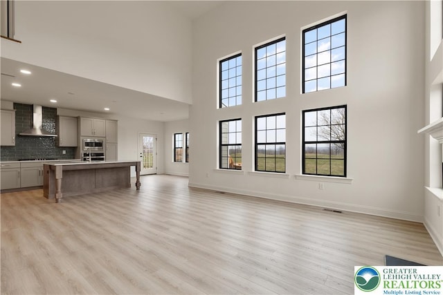1350 Lorton Dr Unit 56, Forks Twp, PA 18040 - unfurnished living room featuring a high ceiling, light wood-type flooring, recessed lighting, and baseboards