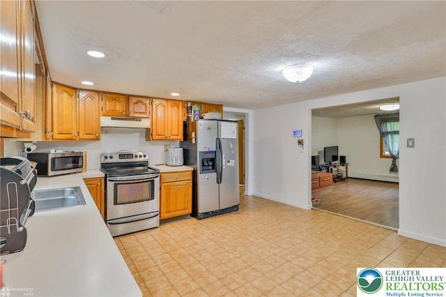 717 Frost Hollow Rd, Easton, PA 18040 - kitchen with appliances with stainless steel finishes, under cabinet range hood, light countertops, a baseboard radiator, and recessed lighting