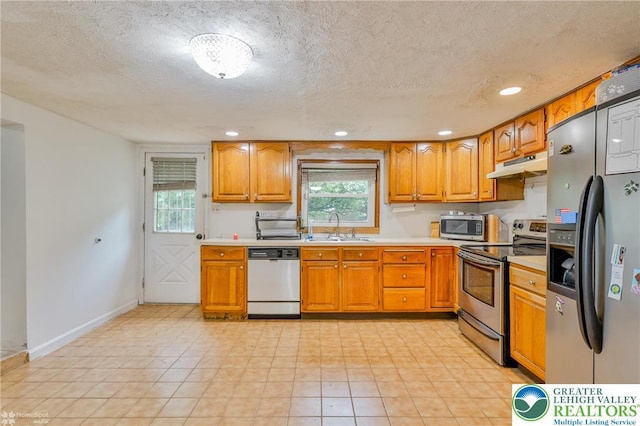 717 Frost Hollow Rd, Easton, PA 18040 - kitchen featuring stainless steel appliances, under cabinet range hood, a sink, light countertops, and brown cabinetry