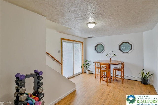 717 Frost Hollow Rd, Easton, PA 18040 - dining space with a textured ceiling, baseboards, and wood finished floors