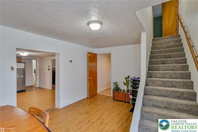 717 Frost Hollow Rd, Easton, PA 18040 - stairs featuring baseboards, a textured ceiling, and wood finished floors