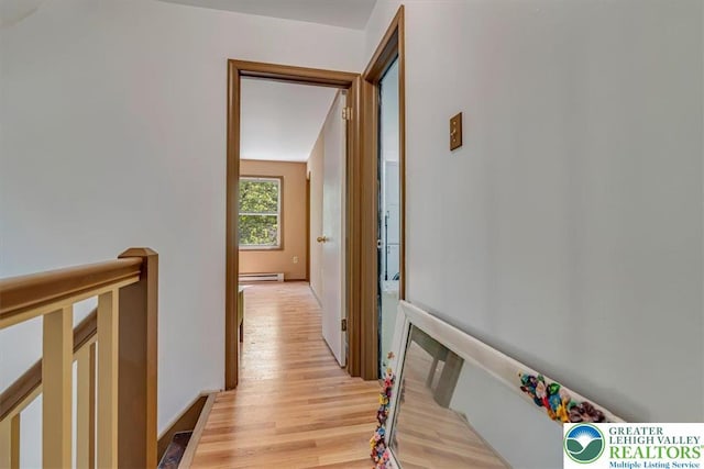 1281 Winding Way, Coolbaugh Twp, PA 18466 - hallway featuring a baseboard radiator, light wood-style floors, and an upstairs landing