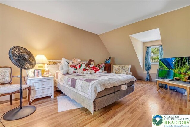 1281 Winding Way, Coolbaugh Twp, PA 18466 - bedroom featuring light wood-type flooring and vaulted ceiling