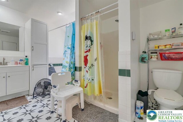 1281 Winding Way, Coolbaugh Twp, PA 18466 - full bathroom featuring a shower stall, toilet, tile patterned floors, and vanity