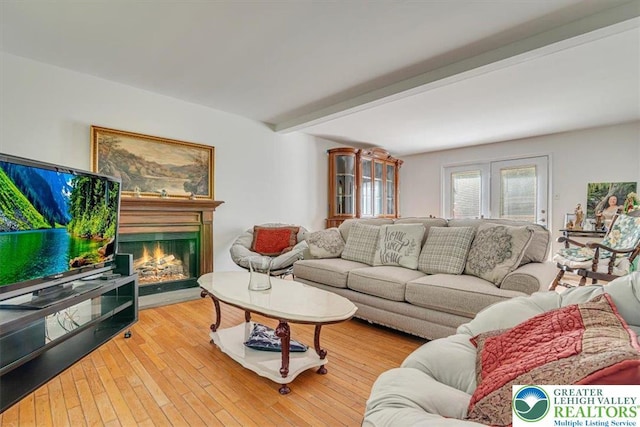 1281 Winding Way, Coolbaugh Twp, PA 18466 - living area with beamed ceiling, a warm lit fireplace, and wood finished floors